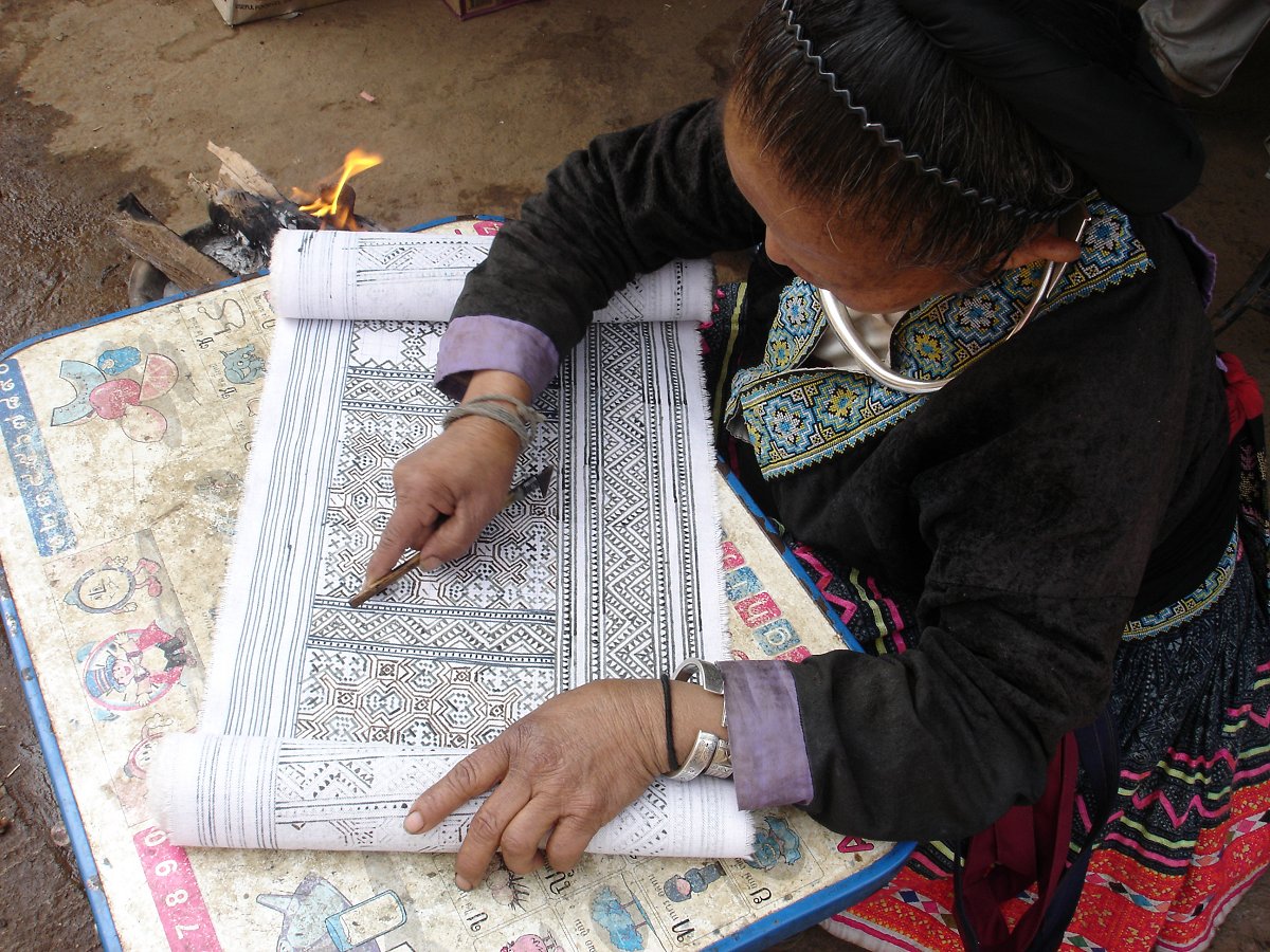 Waxing cotton with a ladao, Thailand